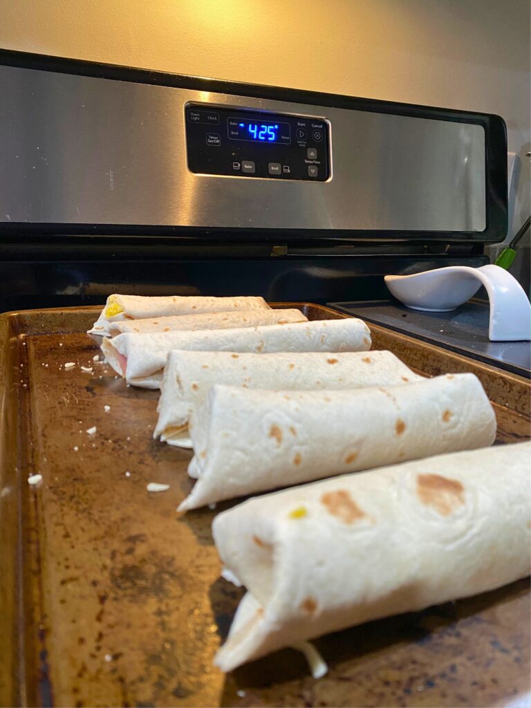 Freezer-friendly burritos fresh out of the oven on a nonstick baking sheet