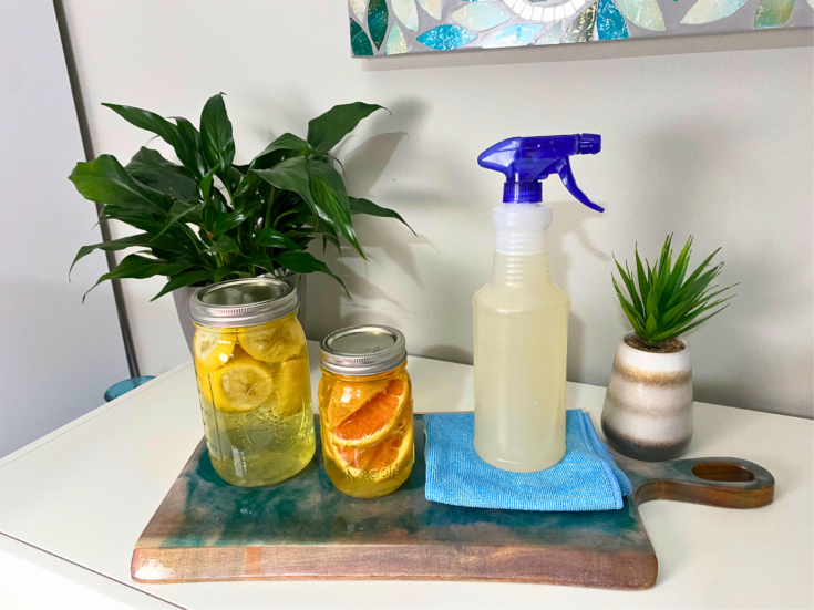 Citrus-scented vinegar with spray bottle solution and cleaning rag