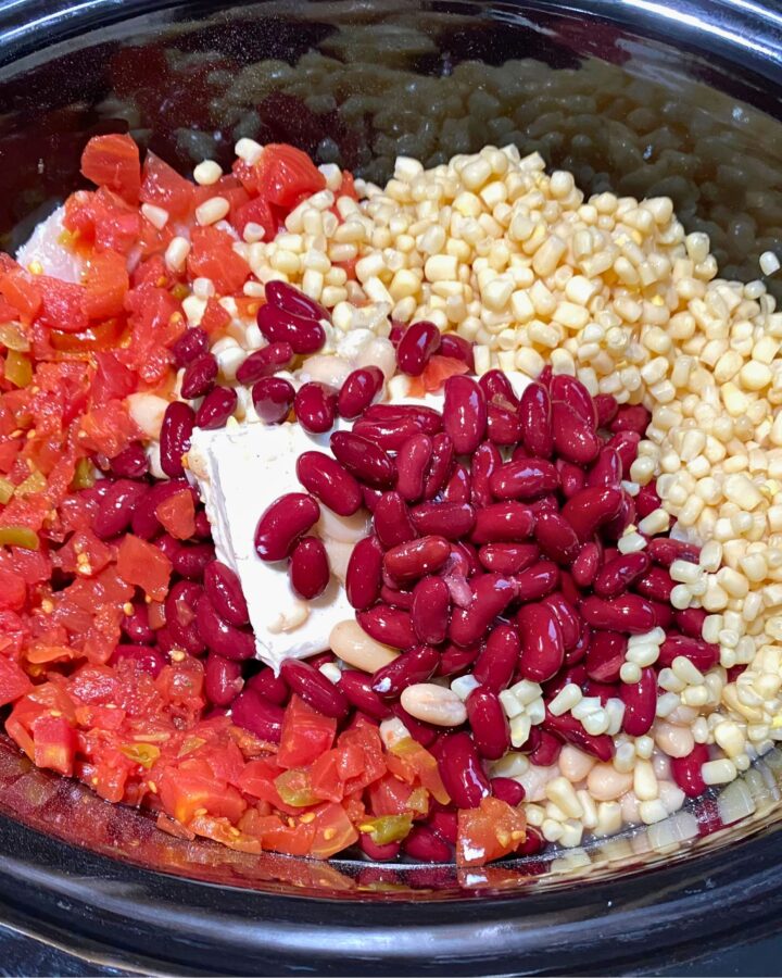 Creamy white chicken chili made with red kidney beans, white corn, and diced tomatoes in a slow cooker