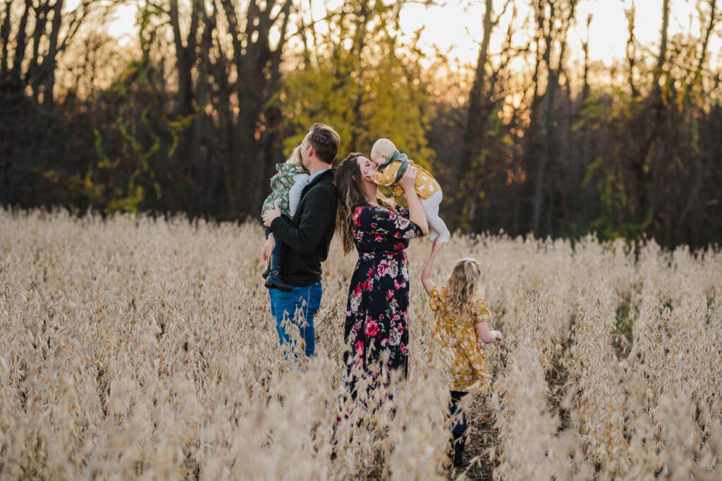 Family of five in a bean field at dusk