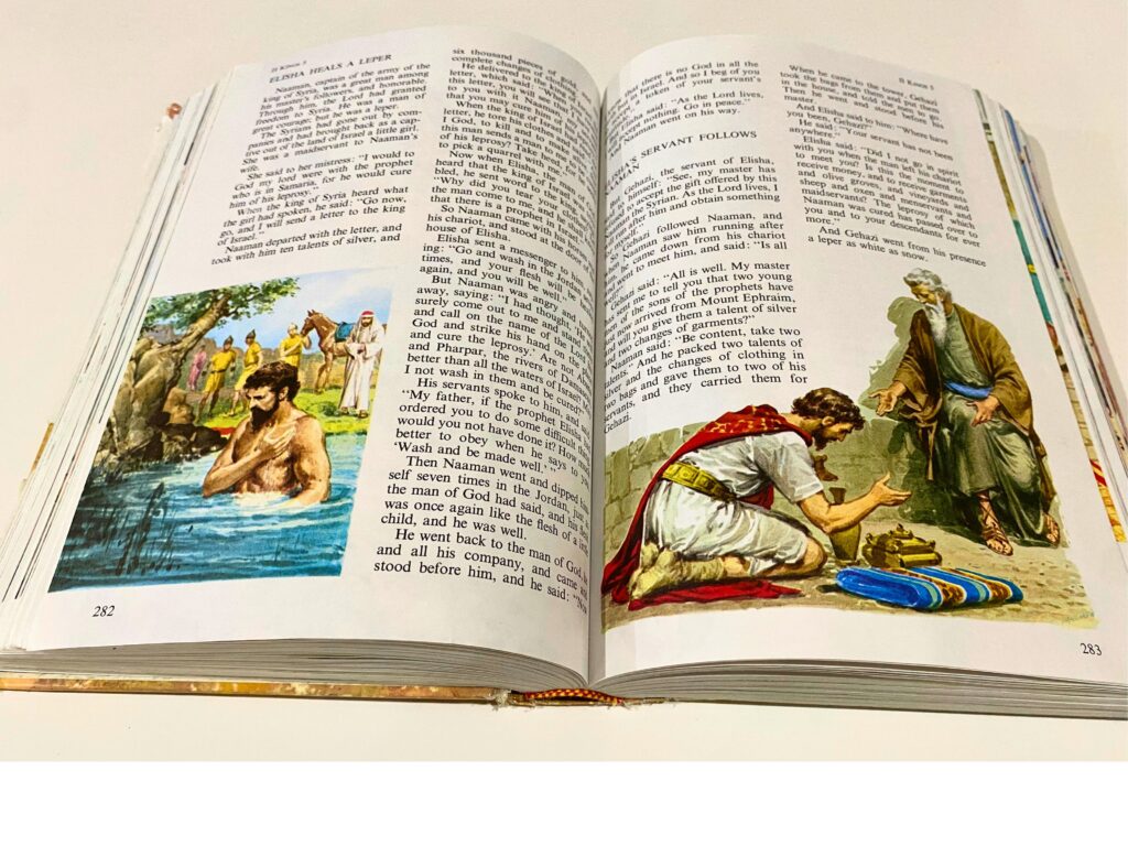 The Children's Bible book open to when Elisha heals a leper