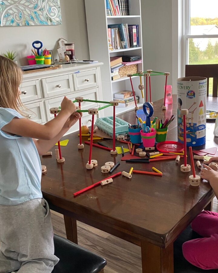 two children playing with tinker toys as part of homeschool curriculum