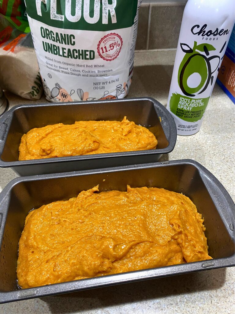 Two loaf pans filled 2/3 of the way with pumpkin bread batter 