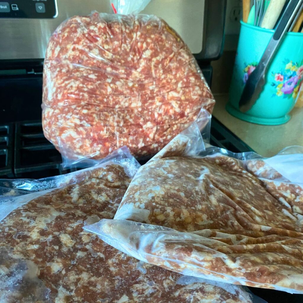 Ten pound bag of breakfast sausage with two one pound freezer bags in front