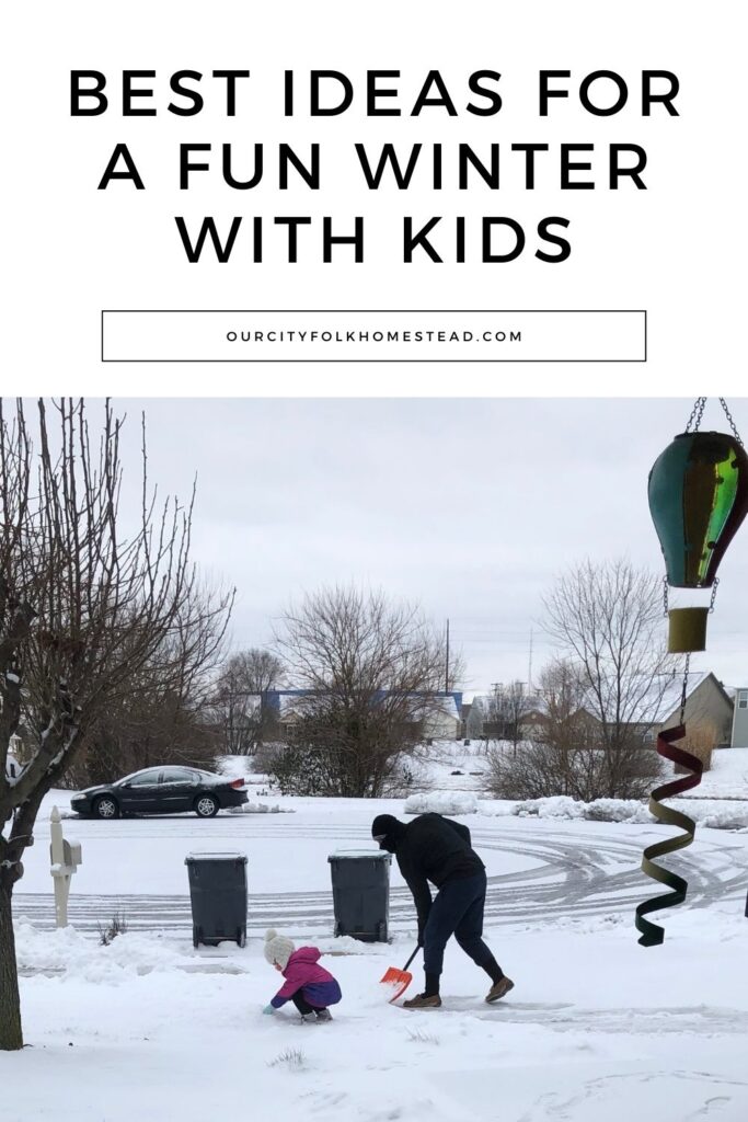 Man shoveling snow off of a driveway while little girl in a pink and purple coat kneels down in the snow beside him